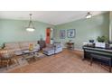 Comfortable living room with neutral-toned sofas, tile floors, pendant lighting, and stylish accents at 5227 Lansdowne Way, Palmetto, FL 34221