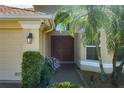 Inviting entrance featuring double front doors, lush greenery, and a well-maintained walkway leading to the home at 5412 72Nd E Ter, Ellenton, FL 34222