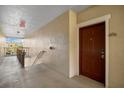 Hallway view to the unit's front door, number 301, including the stairway and exit sign at 5450 Bentgrass Dr # 5-301, Sarasota, FL 34235