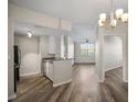 Open concept kitchen with modern countertops that flows to the living space at 5450 Bentgrass Dr # 5-301, Sarasota, FL 34235