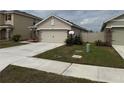 Beige single story home with a 2 car garage, stone accents and well maintained front yard at 5838 Elegant Orchid Way, Sarasota, FL 34232