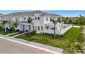 Charming, bright white two-story home featuring an outdoor patio and meticulous landscaping at 6027 White Mangrove Ln, Bradenton, FL 34210