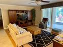 Cozy living room with a neutral color palette, wood floors and a screened-in porch at 6101 34Th W St # 25E, Bradenton, FL 34210