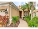 Inviting home exterior with a brick walkway leading to the front door, complimented by lush landscaping at 6103 Aviary Ct, Bradenton, FL 34203