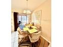 Bright dining area with a round glass table and view into sunroom at 6924 Tuxedo St, Englewood, FL 34224