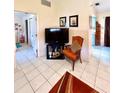 Cozy living room area with tile flooring, comfortable seating, and television at 6924 Tuxedo St, Englewood, FL 34224