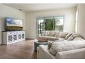 Inviting living room with wood-look floors, comfortable seating, and access to the outdoor patio at 7547 Campus Cv, Sarasota, FL 34243