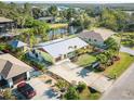 Aerial view of a charming property with defined borders, featuring mature landscaping and water access at 9031 Hilolo Ln, Venice, FL 34293