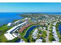 Wide aerial shot of a coastal community with water views, landscaped grounds, and community amenities at 9414 Andover Cir, Bradenton, FL 34210
