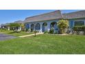Inviting home featuring a lush lawn, paved walkway, and covered porch, perfect for enjoying outdoor living at 3807 41St Street W Ct # 52, Bradenton, FL 34205