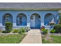 Charming porch with arched entryways, comfortable seating, and beautifully manicured landscaping, creating a warm, inviting atmosphere at 3807 41St Street W Ct # 52, Bradenton, FL 34205