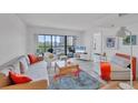 Bright living room features a large window providing natural light and a view, plus modern furnishings at 1001 Benjamin Franklin Dr # 511, Sarasota, FL 34236