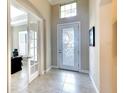 Bright entryway with tile floors, a decorative glass front door, and adjacent office space at 1022 Overlook Ct, Bradenton, FL 34208