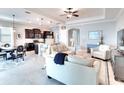 Open-concept living area with tile floors, tray ceiling, and a seamless flow into the modern kitchen at 1022 Overlook Ct, Bradenton, FL 34208