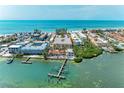 An aerial view showcases the property's waterfront location with docks, and beach access at 1325 Gulf Dr N # 248, Bradenton Beach, FL 34217