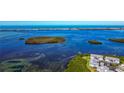Breathtaking aerial of waterfront condo community with bay views and lush greenery at 1389 Perico Point Cir # 140, Bradenton, FL 34209