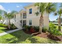 Two-story condo with well-kept lawn and landscaping in front of the building at 200 Gardens Edge Dr # 222, Venice, FL 34285