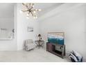 Bright living room area featuring tile flooring, a modern light, and neutral walls at 200 Gardens Edge Dr # 222, Venice, FL 34285