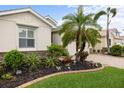 Landscaped front yard with decorative plants, rock accents, and a well-manicured lawn at 2183 Nettlebush Ln, Venice, FL 34292