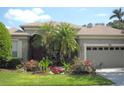 Beautiful home featuring a well-manicured lawn and colorful flower beds enhancing curb appeal at 315 Londonderry Dr, Sarasota, FL 34240
