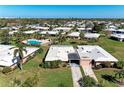 Expansive aerial view of a single-story home with community pool and palm tree landscaping at 3259 Fairhaven Ln # 211, Sarasota, FL 34239