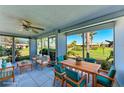 Enclosed lanai features tile flooring, ceiling fan, and expansive views of the well-maintained, lush green lawn and community landscaping at 3259 Fairhaven Ln # 211, Sarasota, FL 34239
