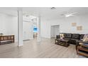 Open-concept living room with a leather couch and hardwood floors offers a versatile layout for entertaining and relaxation at 3319 Mayflower St, Sarasota, FL 34231