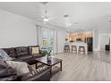 Spacious living room features an open concept design, gray laminate floors and backyard access at 3319 Mayflower St, Sarasota, FL 34231
