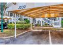 Assigned covered parking space showing well maintained landscaping and close proximity to unit entry at 3608 54Th W Dr # 202, Bradenton, FL 34210