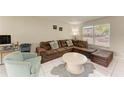 Cozy living room showcasing a comfortable couch, tile flooring and ample natural light at 3717 Delta St # 95, Sarasota, FL 34232