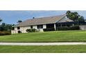 Expansive backyard features lush green lawn, an enclosed porch, and mature landscaping at 3799 Countryside Rd, Sarasota, FL 34233