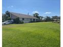 Exterior view of a well-maintained home, lush lawn and beautiful mature landscaping at 3799 Countryside Rd, Sarasota, FL 34233