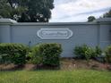 The 'CountryPlace' sign surrounded by greenery is made of painted brick at 3799 Countryside Rd, Sarasota, FL 34233