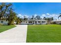 Inviting single story home with manicured lawn and long driveway at 426 S Shore Dr, Sarasota, FL 34234