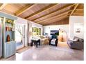 Inviting living room featuring a vaulted wood ceiling, large window, and comfortable seating arrangement at 426 S Shore Dr, Sarasota, FL 34234