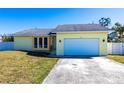 Inviting single-story home with a spacious two-car garage and a lush green front lawn under a clear sky at 4659 Alligator Dr, Venice, FL 34293