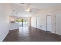 Spacious open-concept living area with modern ceiling fans, beautiful laminate flooring, and lots of natural light at 4659 Alligator Dr, Venice, FL 34293