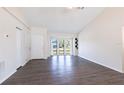 Bright living room featuring elegant laminate flooring, ample natural light, and soaring high ceilings for an airy feel at 4659 Alligator Dr, Venice, FL 34293