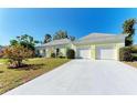 Home with a two-car garage, a concrete driveway, and a neatly manicured lawn at 5 Barbados Rd # 31, Englewood, FL 34223