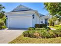 Beautiful home featuring lush landscaping, a wide driveway, and a pristine two-car garage on a sunny day at 5234 Aqua Breeze Dr, Bradenton, FL 34208