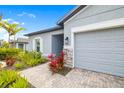 Close-up of the home's entrance, showcasing a paved walkway and lush landscaping at 5533 Patano Loop, Palmetto, FL 34221