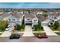 Aerial view of a charming home nestled in a well-planned community with landscaped streets at 6136 Voyagers Pl, Apollo Beach, FL 33572