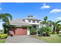 Beautiful home with a brick driveway, two-car garage, and well-maintained landscaping at 6208 Signature Pointe Ln, Bradenton, FL 34210