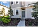 Inviting front entrance with a gray door and decorative landscaping details at 6265 Fairmont Ln, Palmetto, FL 34221