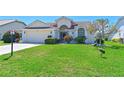 Well-maintained front yard with beautiful landscaping, exterior view, and avian wildlife at 6514 Stone River Rd, Bradenton, FL 34203