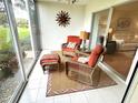 Enclosed lanai with tile flooring, comfortable seating, and plenty of natural light at 6707 Stone River Rd # 105, Bradenton, FL 34203