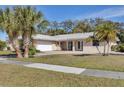 Charming single-story home featuring a manicured lawn and a welcoming entrance at 7211 Antigua Pl, Sarasota, FL 34231