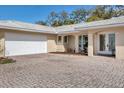 Close-up of a home showing the garage, main entry and brick paver driveway at 7211 Antigua Pl, Sarasota, FL 34231