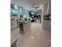 Bright, modern kitchen features a center island, stainless steel appliances, and tile flooring at 728 41St St St, Sarasota, FL 34234