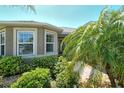 Inviting front entrance with lush landscaping and a stone walkway leading to the front door at 8996 Excelsior Loop, Venice, FL 34293